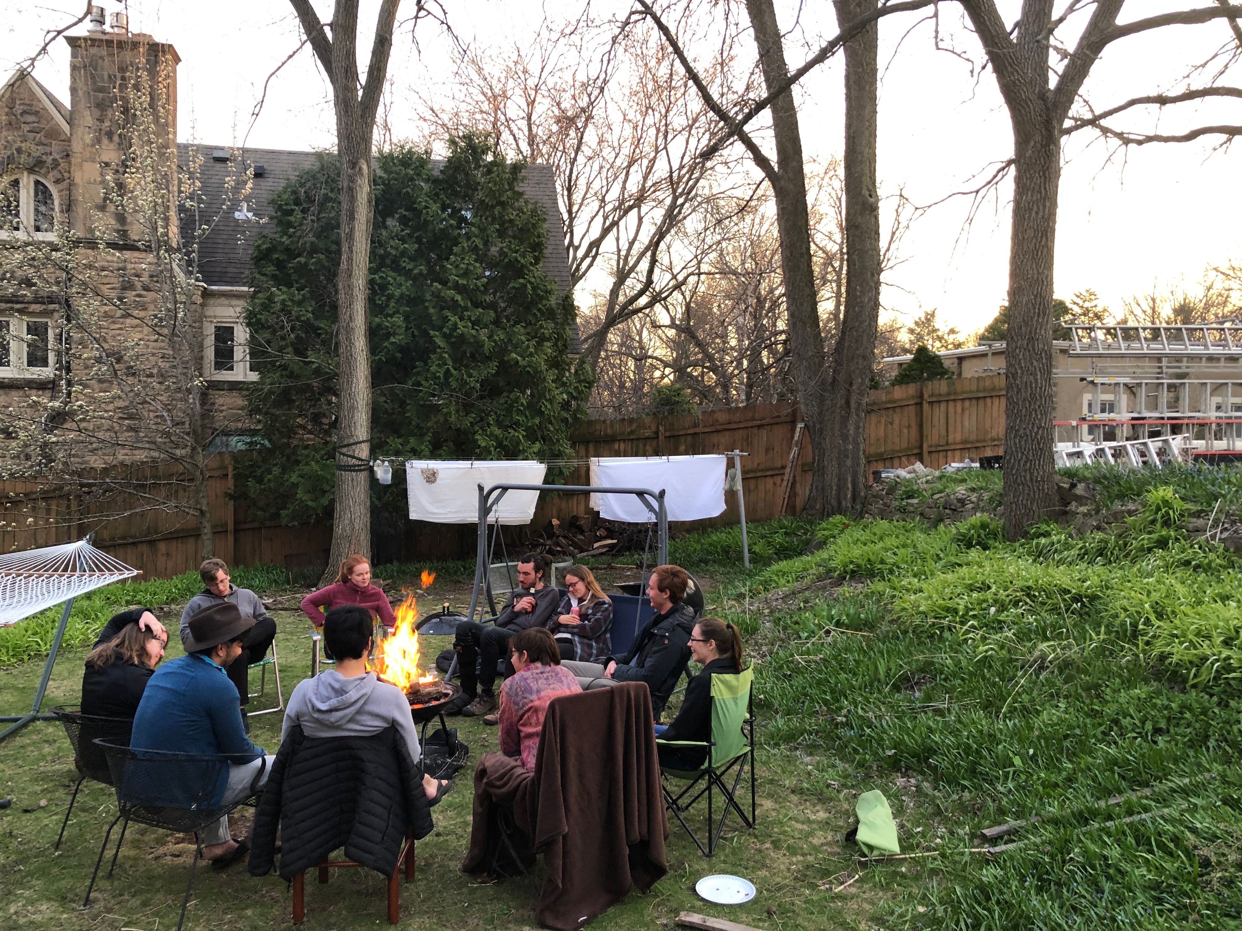 Summiteers sit around a bonfire in the front lawn. (Circa summer 2020)