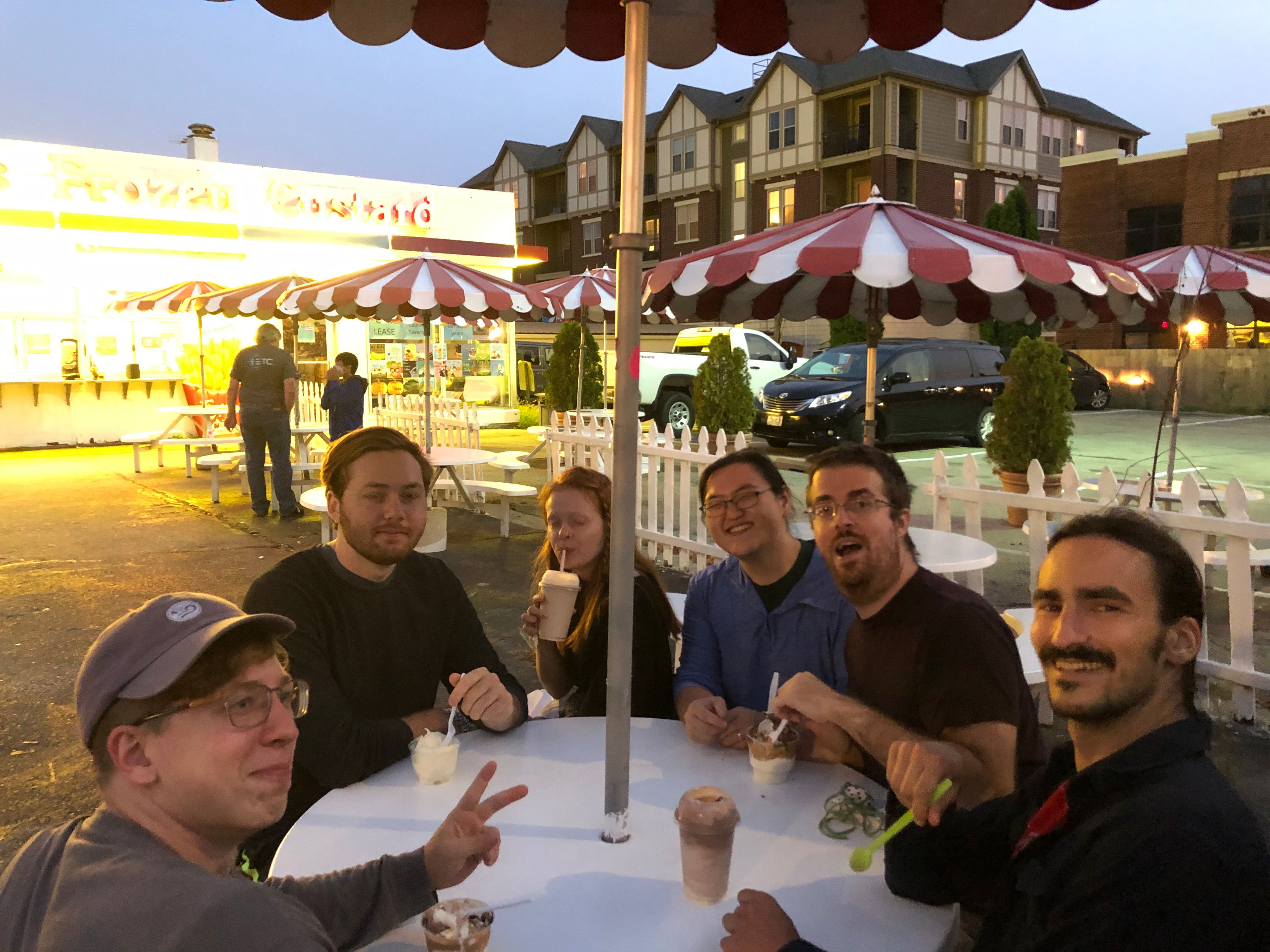 Summiteers sit at picnic table in the evening enjoying custard at Michaels on Monroe Street. (Circa summer 2020)