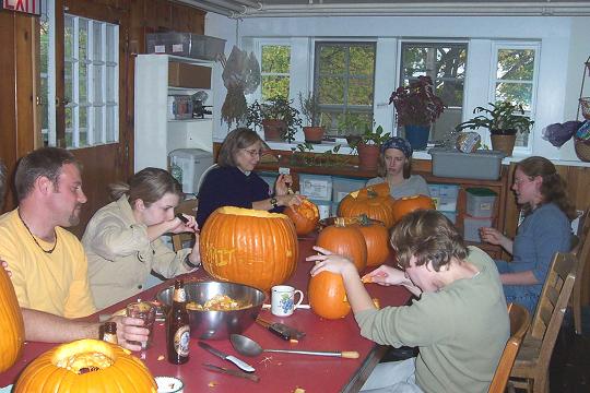 Summiteers carve Halloween pumpkins in dining room