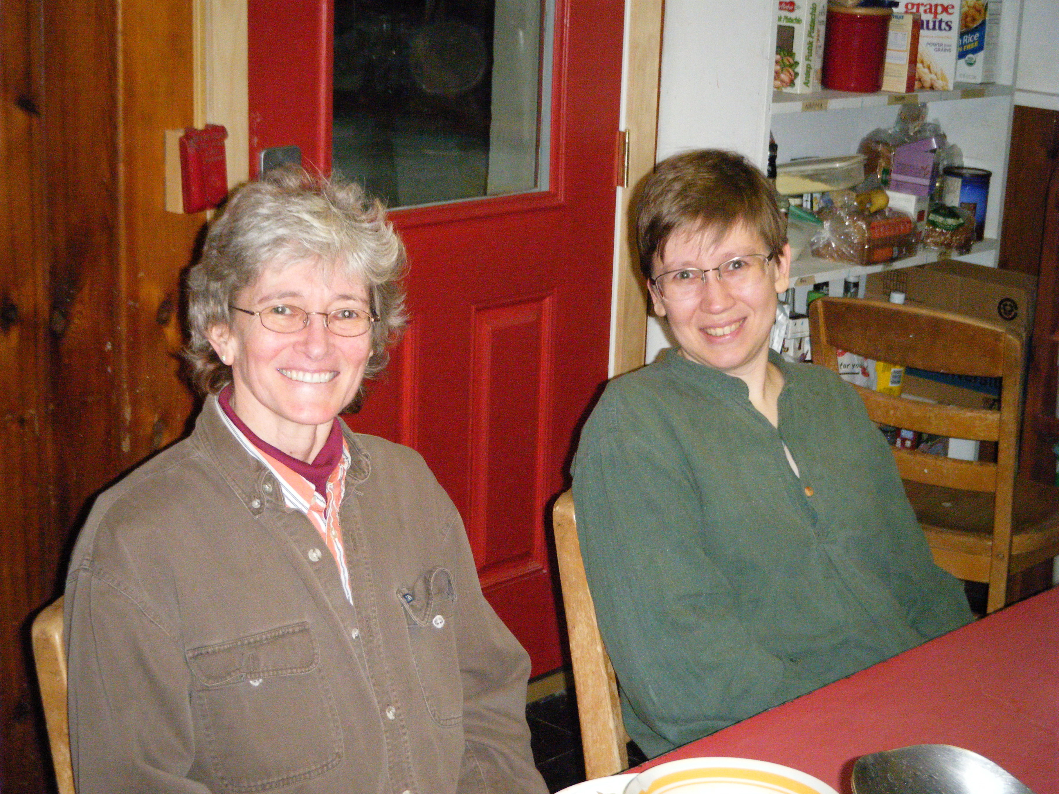 A Summiteer and her guest sit at the dining room table