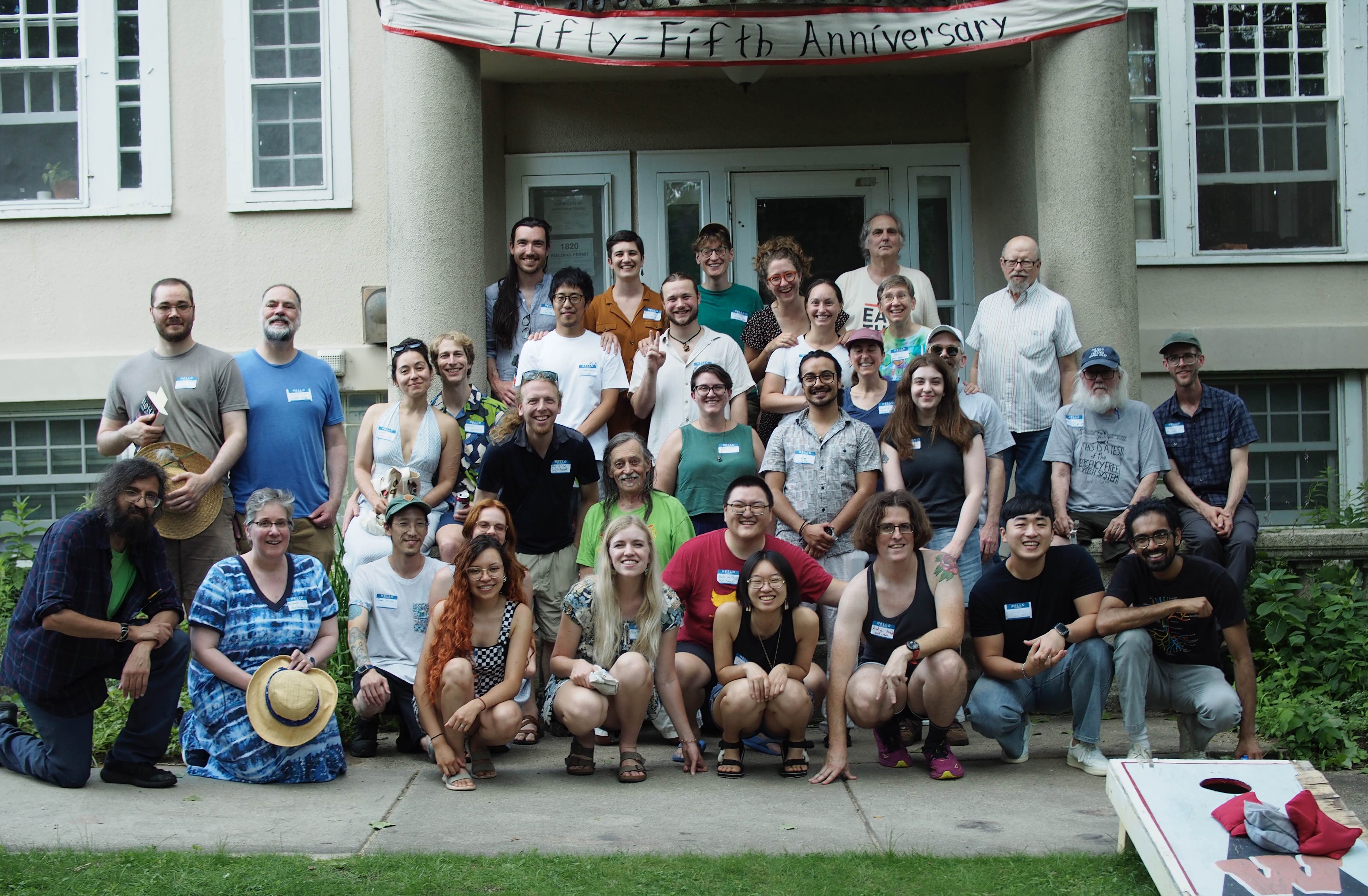 Summiteers and friends posing in front of the house for the 55th Anniversary Party (Summer 2025)