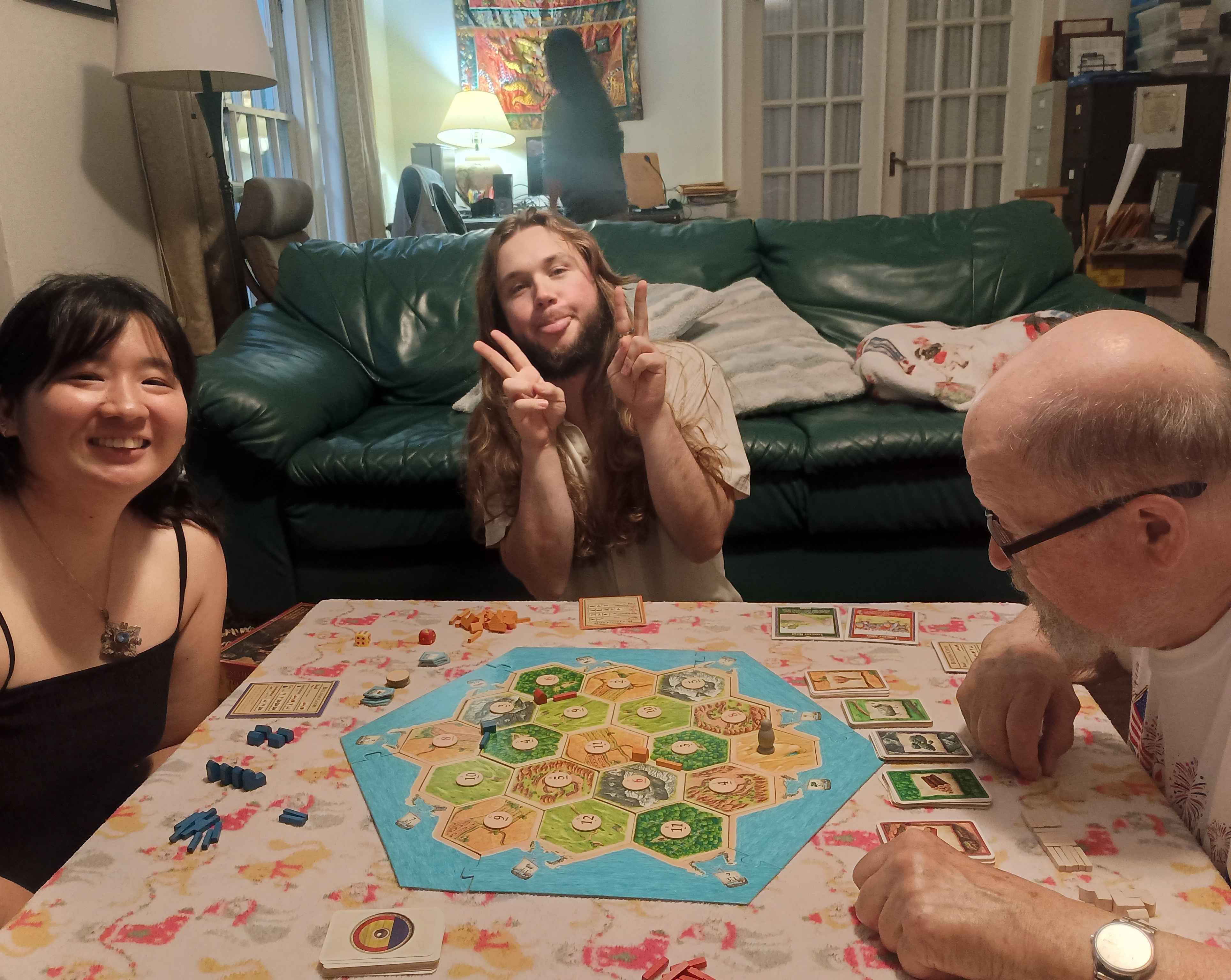 Three Summiteers playing Catan, the board game